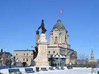 11  Le Monument Samuel de Champlain, devant le Château Frontenac, rend hommage au fondateur de la Ville de Québec en 1608. La ville doit son nom au mot algonquin (peuple autochtone) "Kébek" signifiant "là où le fleuve se rétrécit" du fait de la perte de largeur du fleuve Saint-Laurent à cet endroit. En arrière-plan, l'ancien Bureau de Poste abrite le Musée du Fort et Parcs Canada.