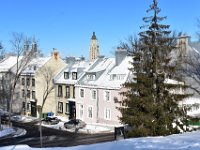 4  Maisons typiques du Vieux-Québec avec mansardes, toits métalliques, boiseries colorées sur façades de pierre dans la rue Sainte-Ursule, avec le profil effilé de l'Edifice Price en toile de fond.